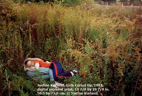 Justine Kurland, Girls Curled Up, 1997, digital pigment print, 19 7/8 by 29 7/8 in.  50.5 by 75.9 cm. © Justine Kurland.